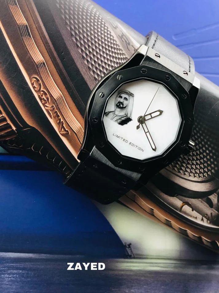 Luxury watch with detailed case and white face on a blue background, featuring the brand 'Zayed'.