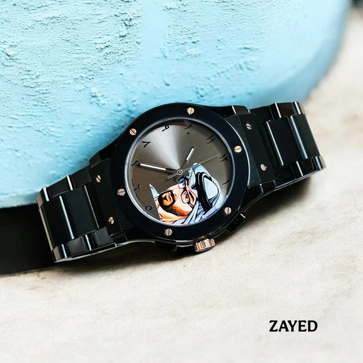 Black watch with a unique face design on a textured surface, brand 'Zayed' visible.