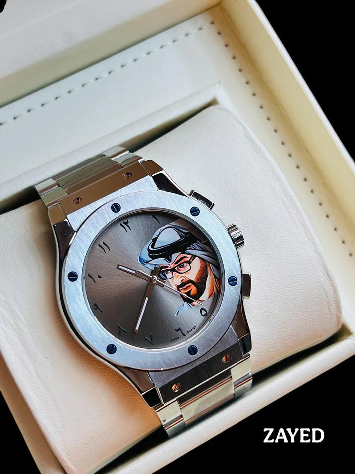 Silver watch with a unique face design on a white cushion in a box, brand 'Zayed' visible.