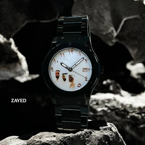 Black wristwatch with unique face design on a rocky surface, brand 'Zayed' visible.