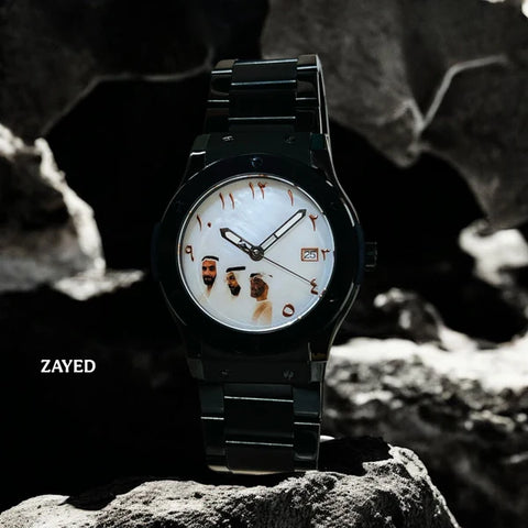 Black wristwatch with unique face design on a rocky surface, brand 'Zayed' visible.